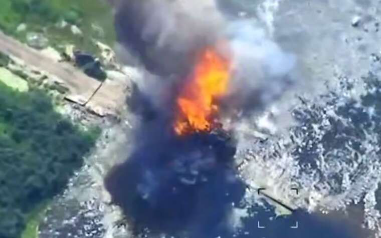 In the Armed Forces of Ukraine, a drone was shown destroying a Russian truck with a gun on a bridge