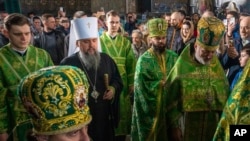 Предстоятель Православной Церкви Украины митрополит Эпифаний (в центре) совершает службу в Вербное воскресенье в Киево-Печерской Лавре, наиболее уважаемом православном месте Украины в Киеве, Украина, в воскресенье, 9 апреля 2023 года. (AP Photo/Adam Pemble)